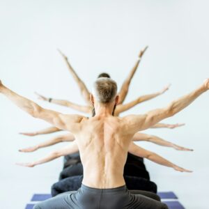 Man in yoga pose with multiple arms on the background