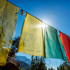Prayer flags of Tibetan Buddhism with Buddhist mantra on it in Dharamshala monastery temple. India