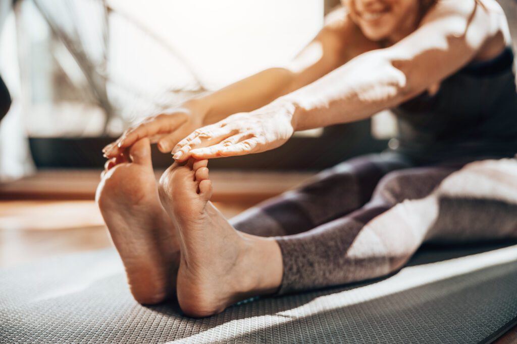 Woman Practicing A Stretching Yoga Exercises At Home